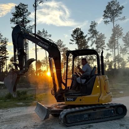 Hinson excavator on site at sundown
